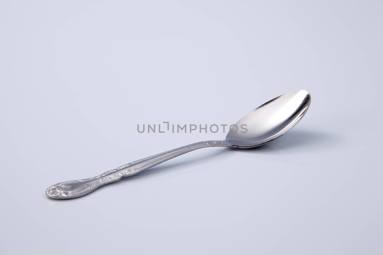 Metal tea spoon isolated on white