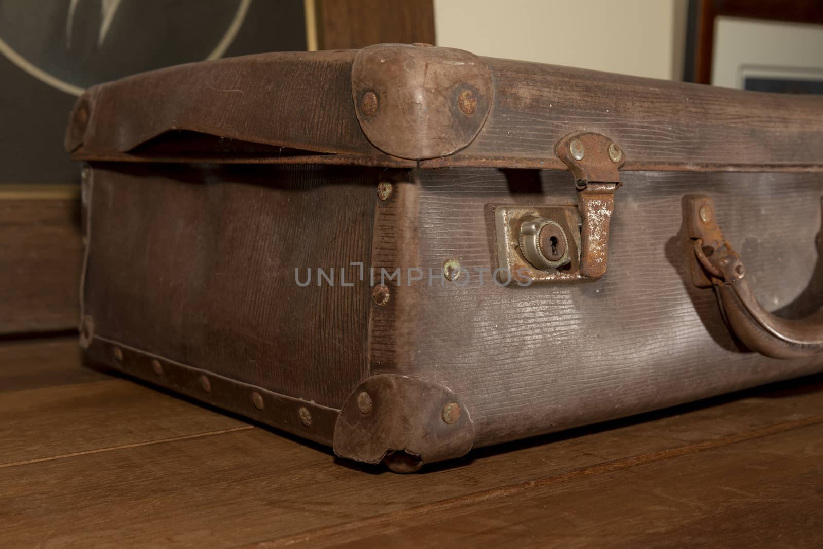 A rusty lock on an old brown leather suitcase by WittkePhotos