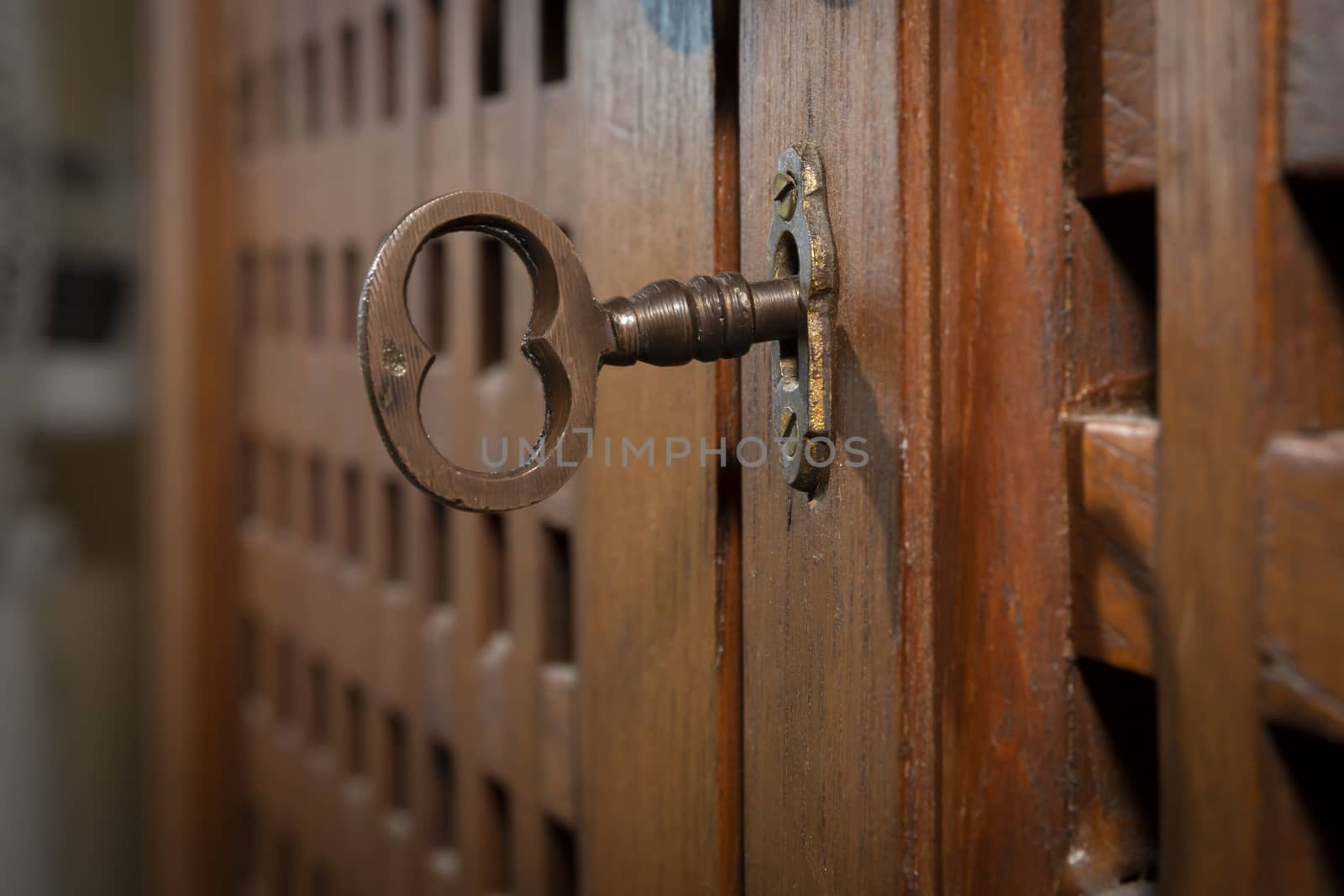 An antique key in an old wooden cupboard by WittkePhotos