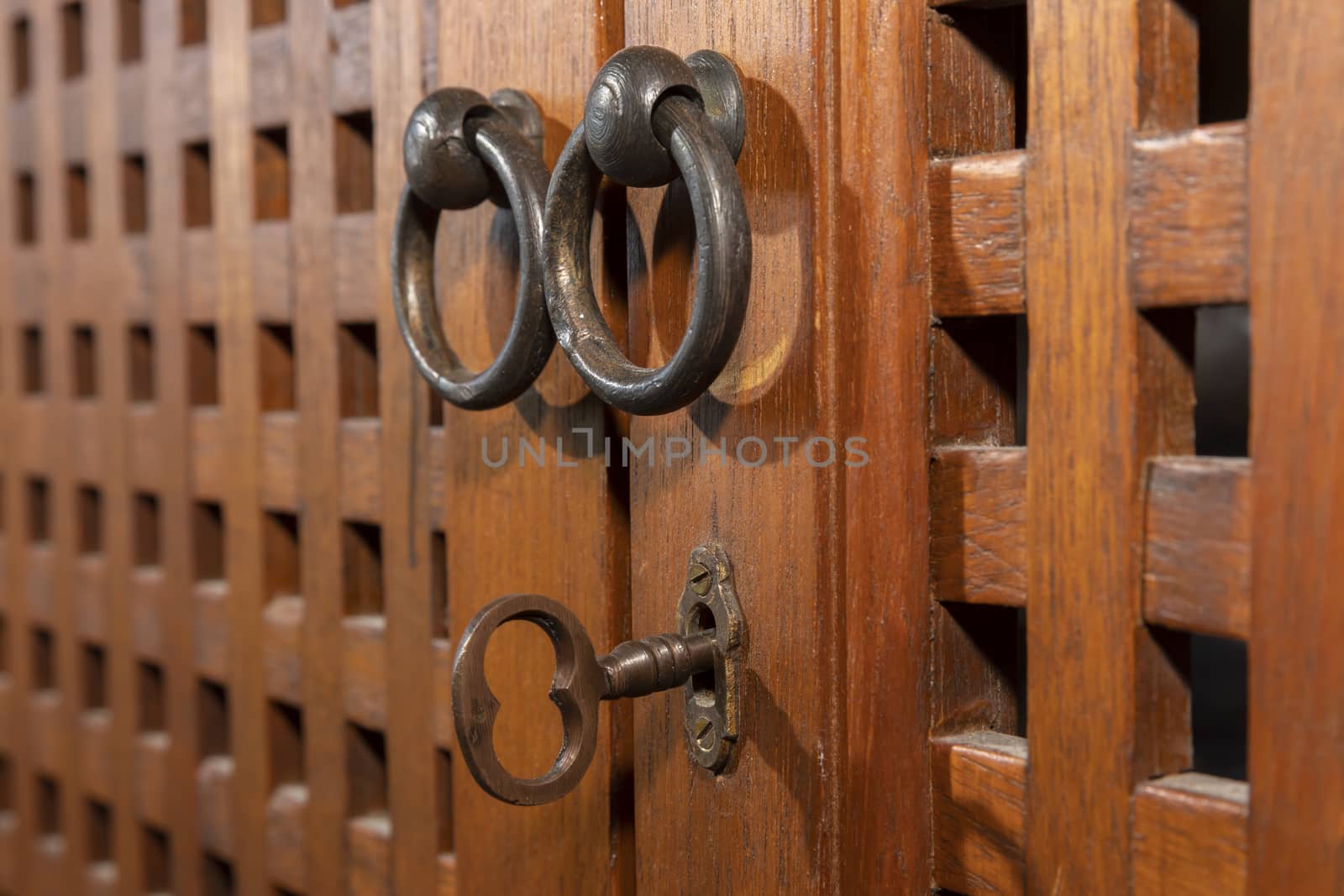 An antique key in an old wooden cupboard