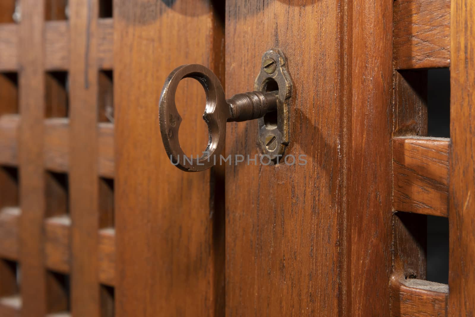 An antique key in an old wooden cupboard by WittkePhotos