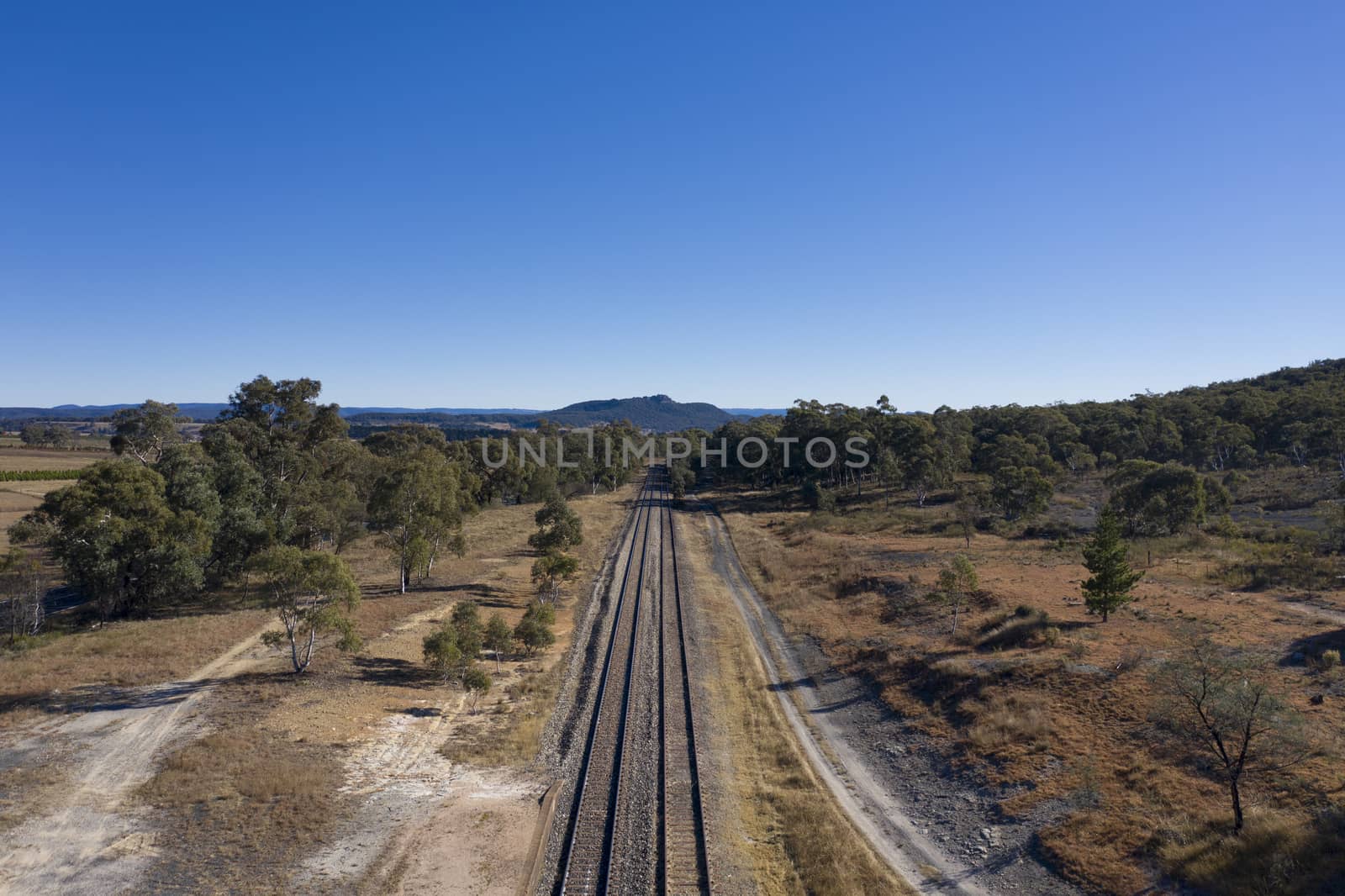 Railway tracks heading into the Australian outback.