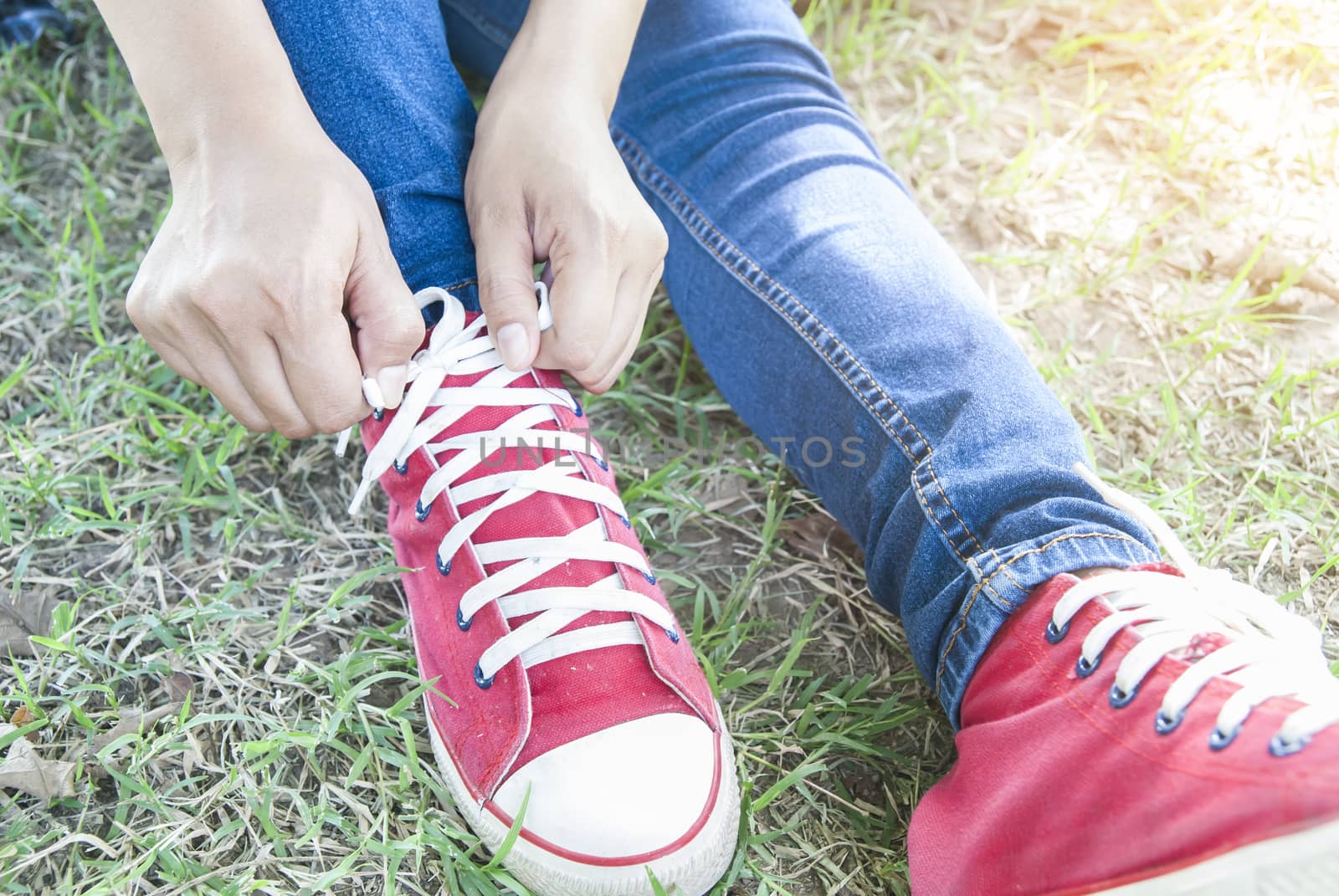close up of woman tying shoe laces by Gobba17