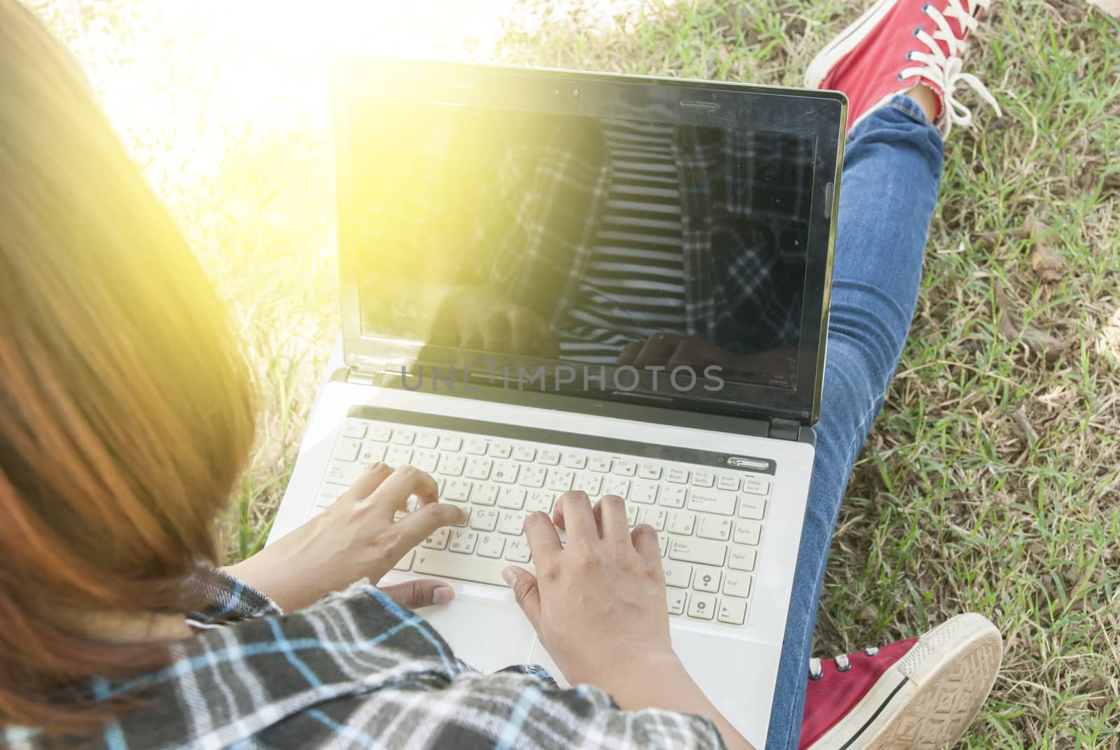 woman using a laptop computer at park by Gobba17