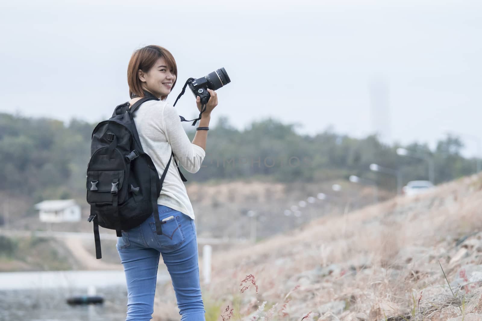 Asian woman with camera outdoor
