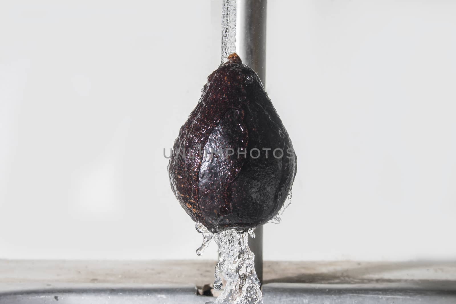 Fresh avocado cleaning with falling water,Healthy food