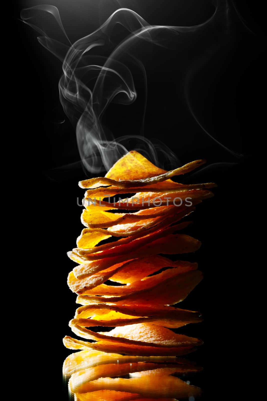 hot mexican nachos tortilla chips stack with smoke, black background by nikkytok