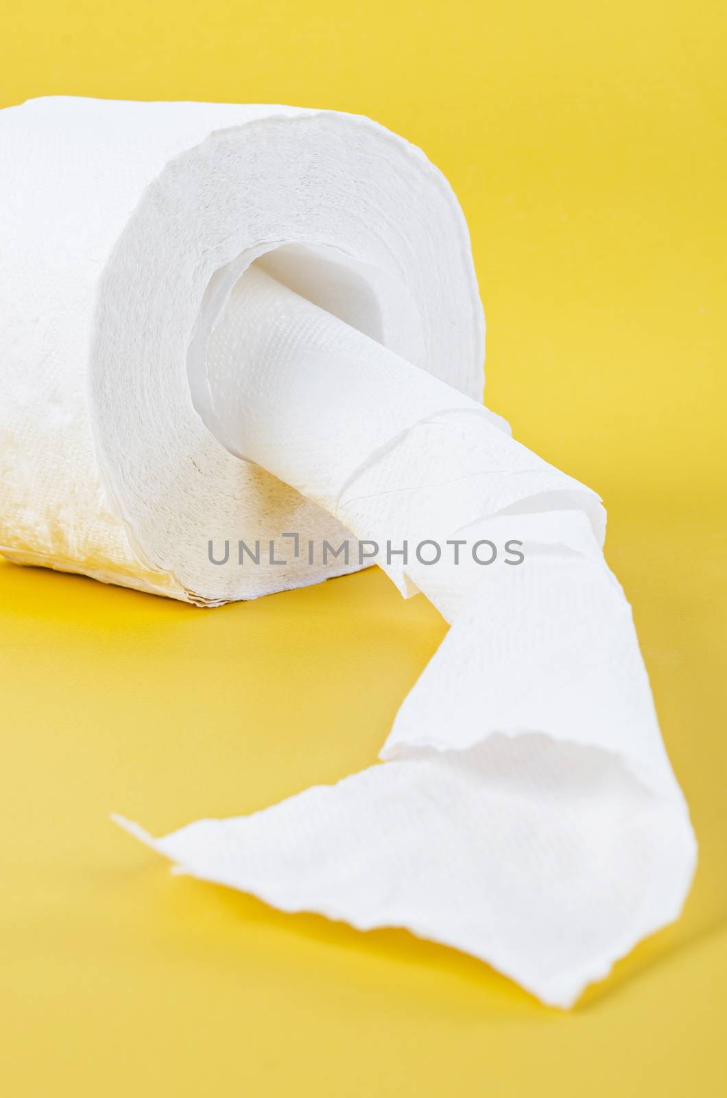 Tissue paper roll on the yellow background.