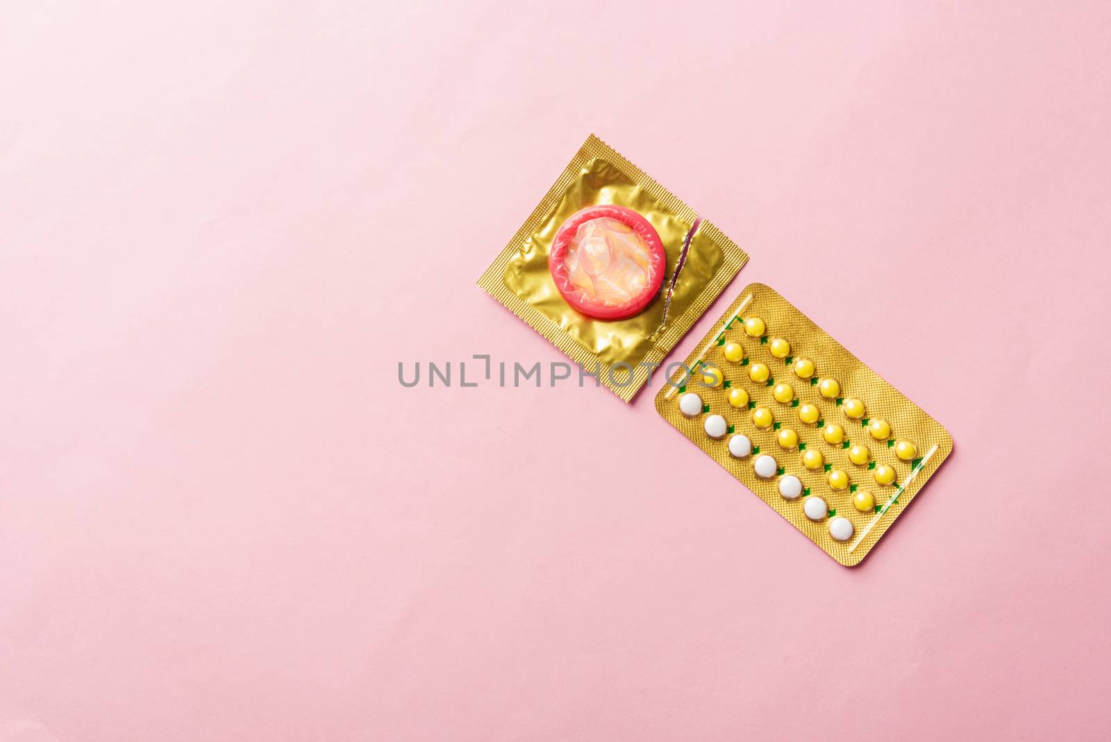condom on wrapper pack and contraceptive pills blister by Sorapop