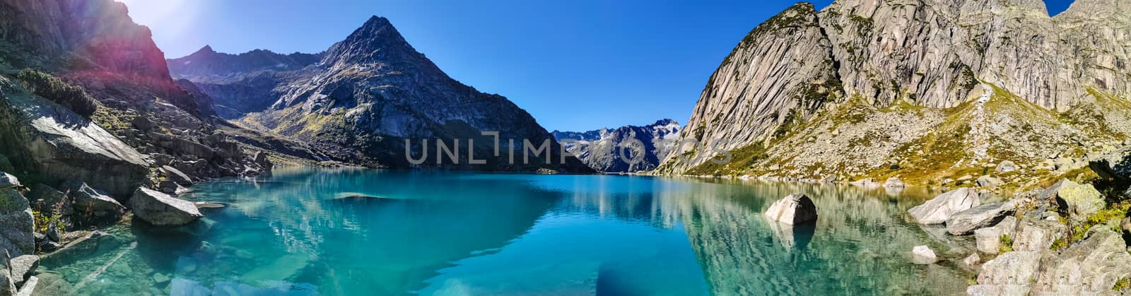 Gelmersee. Dam in the Swiss alps for Hydro power. Clear Blue lake with clear sky.