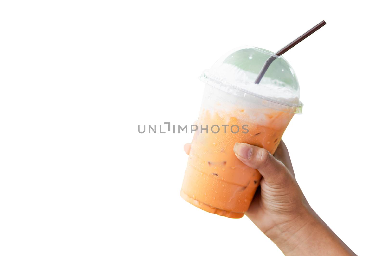 Closeup hand holding glass of ice thai tea on white background