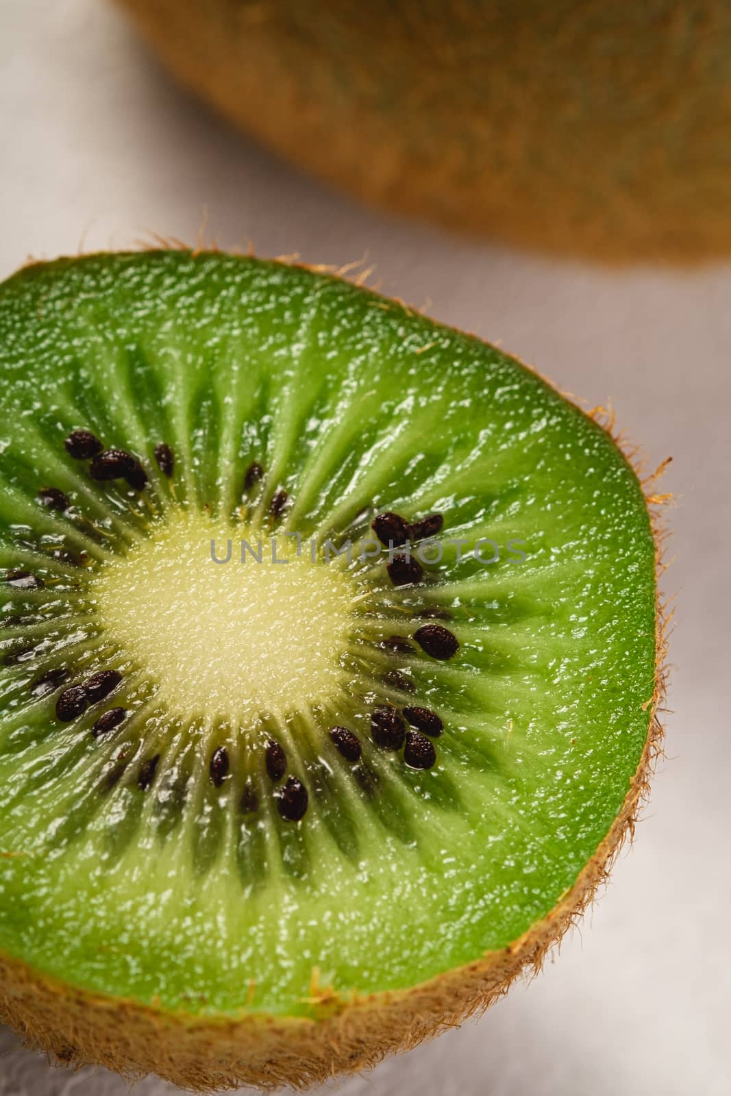 Kiwi fruits half sliced on white background, macro