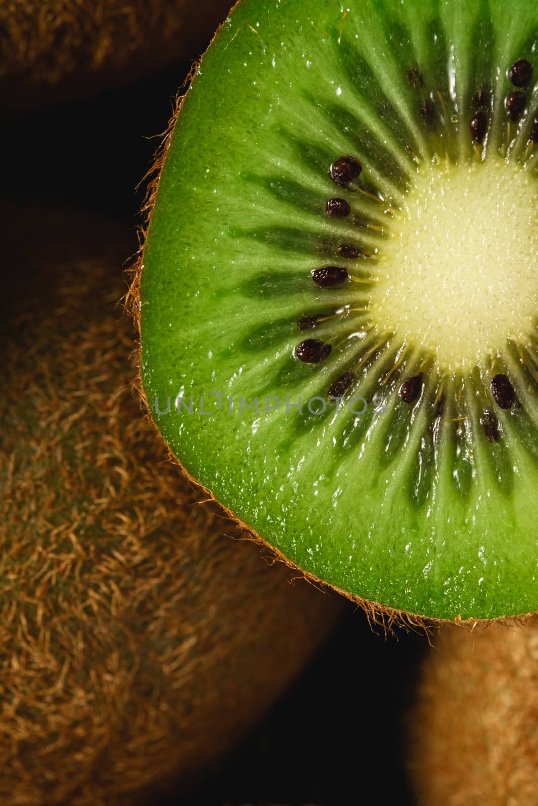 Kiwi fruit half sliced close up macro, healthy lifestyle and food, vibrant green color
