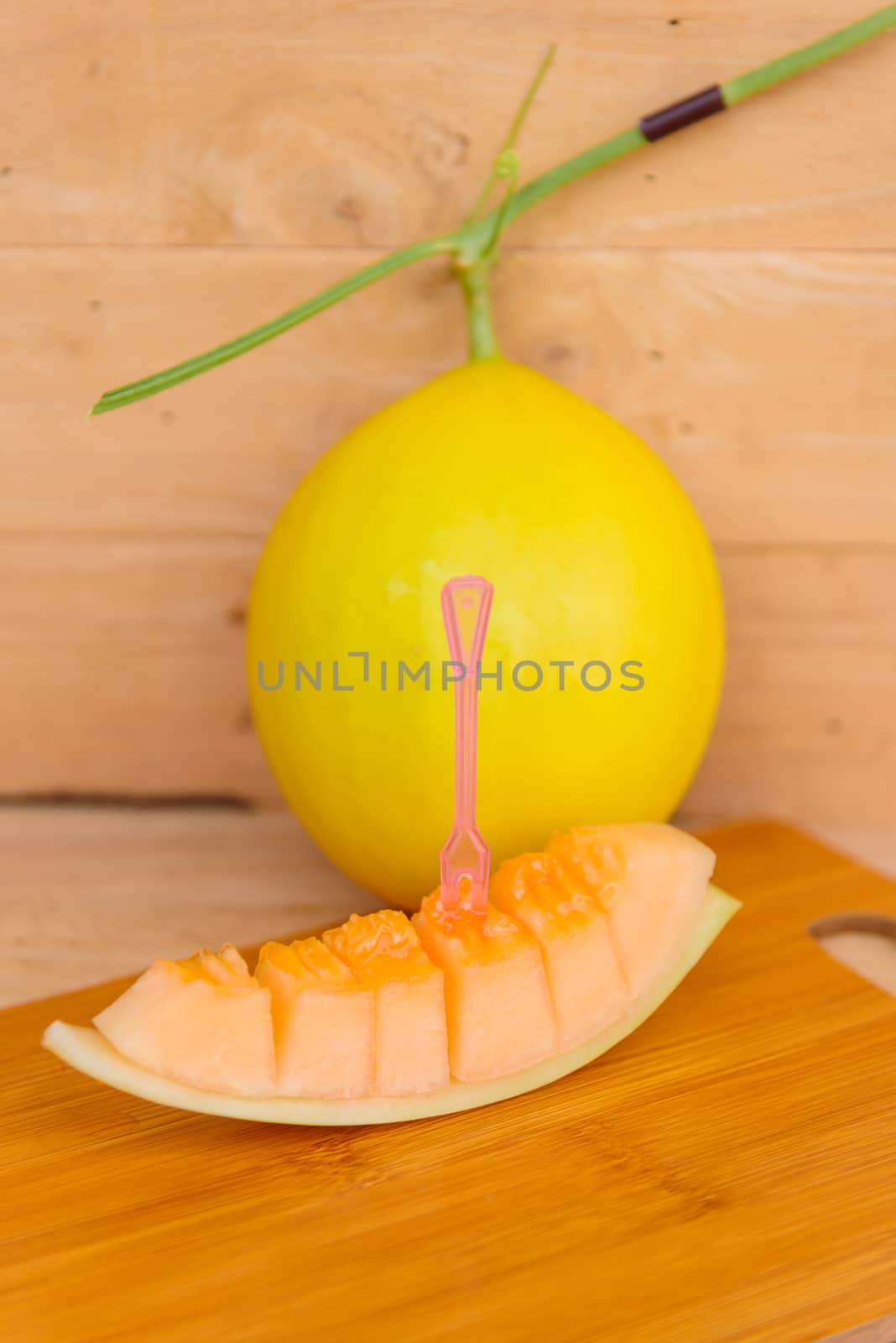 fresh golden melon on wood plate by rukawajung