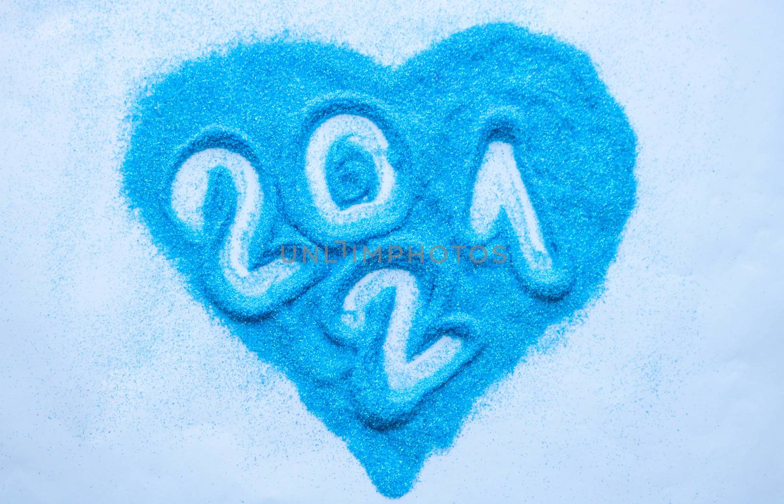 Heart of blue sequins. Numbers 2021 on blue sequins in the shape of a heart.Happy new year 2021.New year's concept
