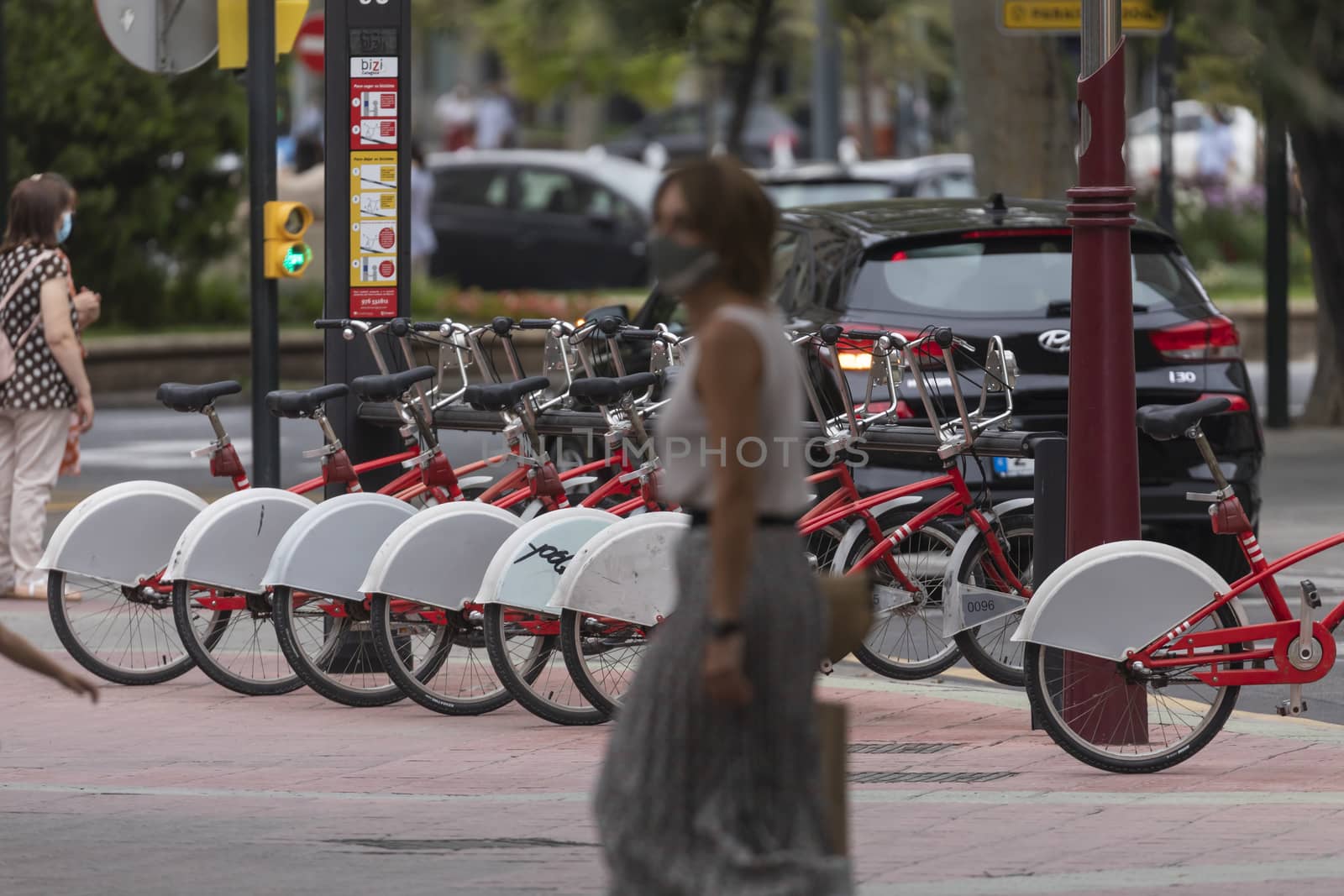 Zaragoza, Spain - August 18, 2020: A woman walking with face mask by alvarobueno