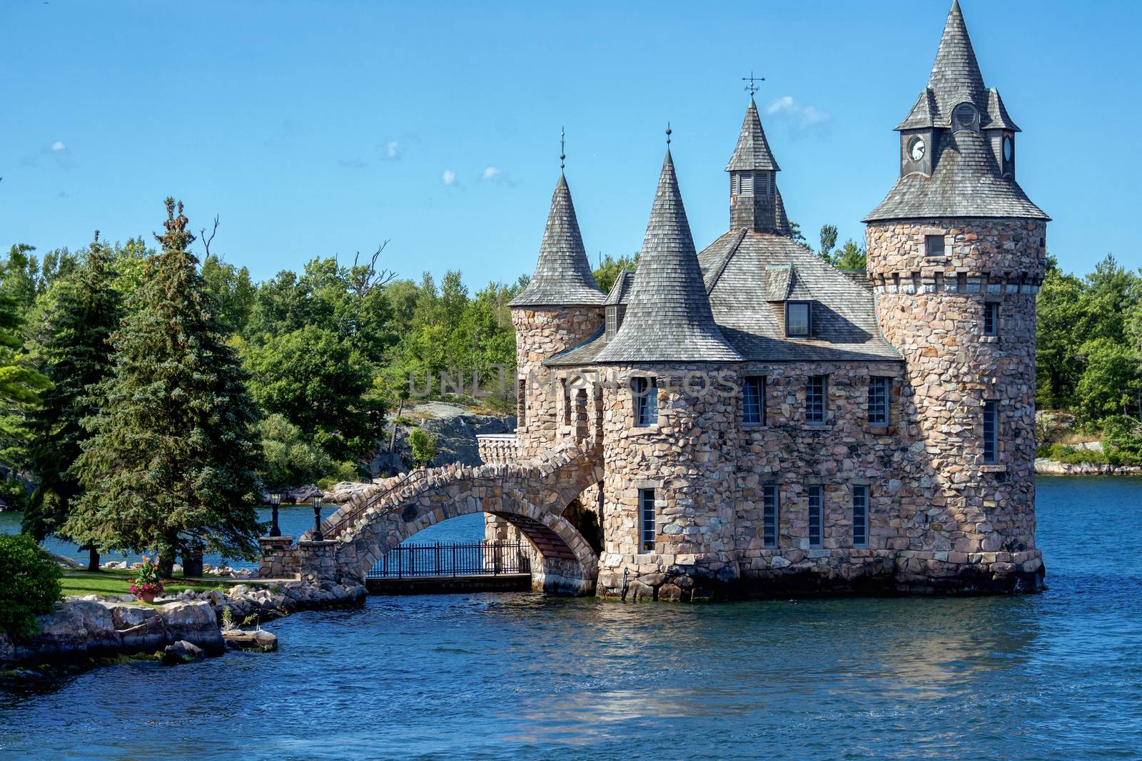 A fragment of a large island with a castle built of stones with a bridge connecting the castle with the island