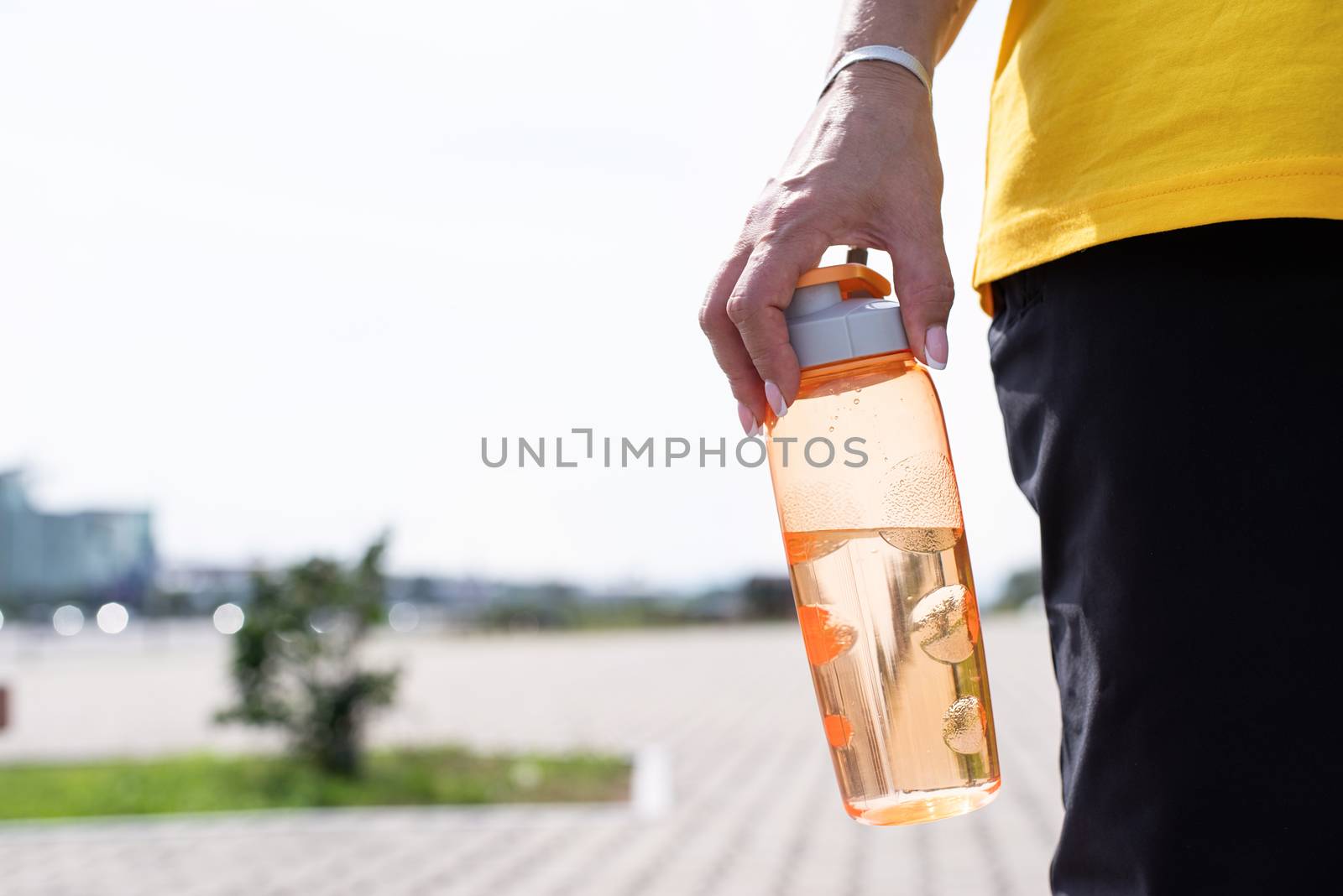 Sport and fitness. Senior sport. Active seniors. woman with the shaker in her hand outdoors in the park