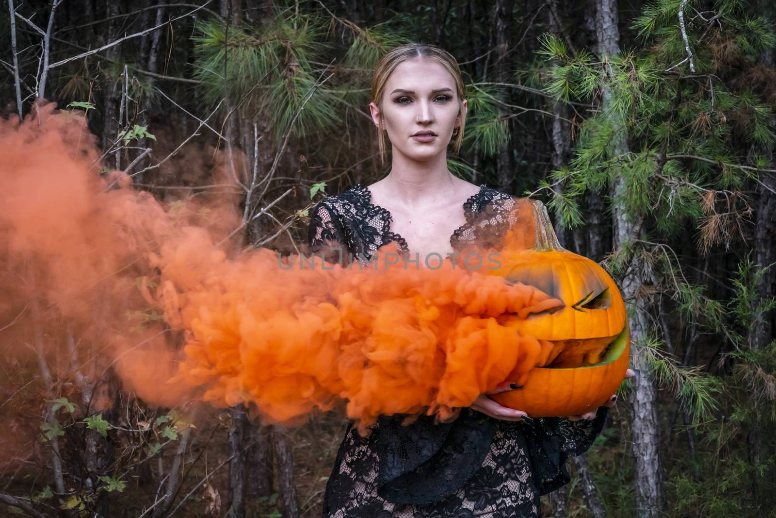 Blonde Model Posing With A Smoking Pumpkin by actionsports