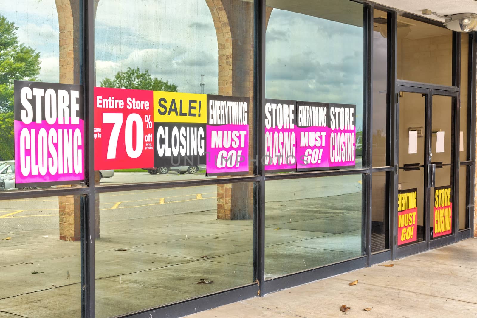 Going Out of Business Signs in Retail Store Windows by stockbuster1