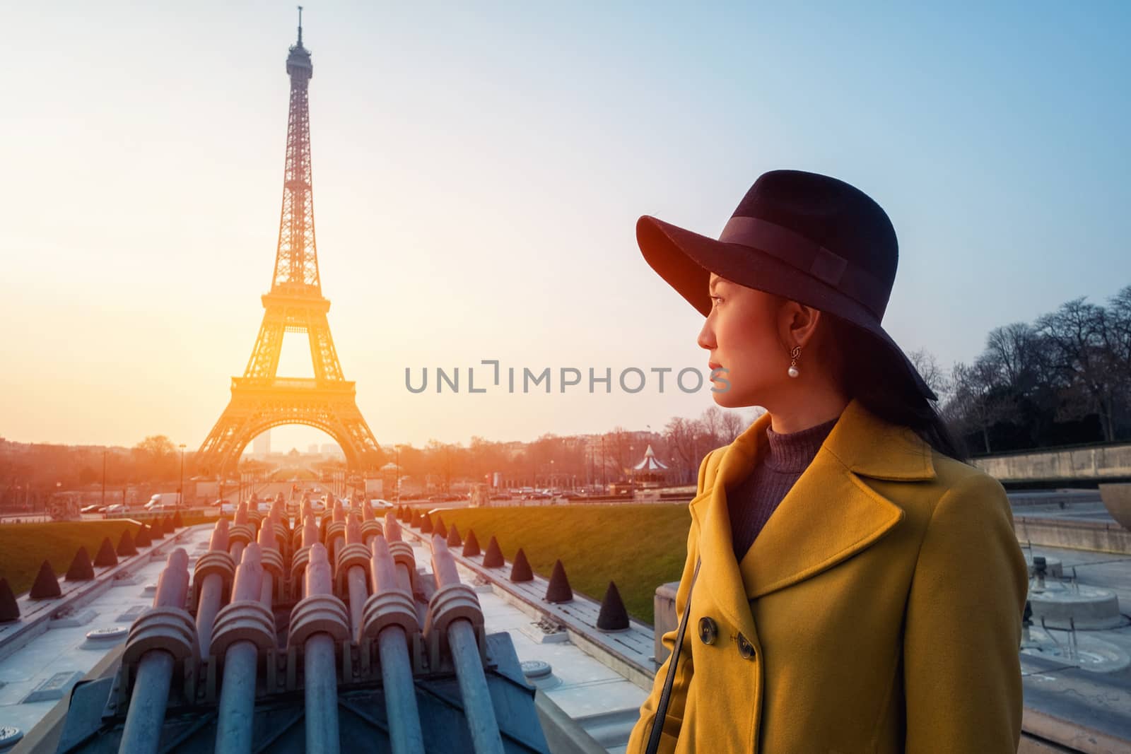 Eiffel Tower tourist posing smiling by Eiffel Tower, Paris, Fran by Surasak