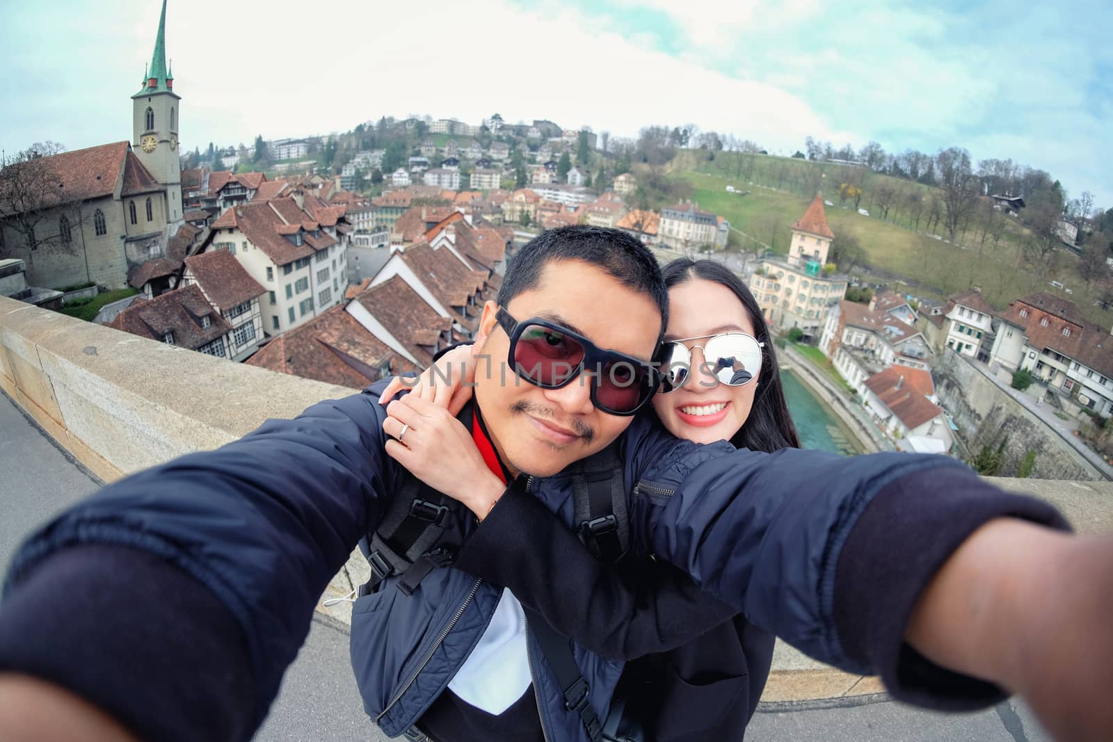 Young Couple Tourists selfie with mobile phone near old town in  by Surasak