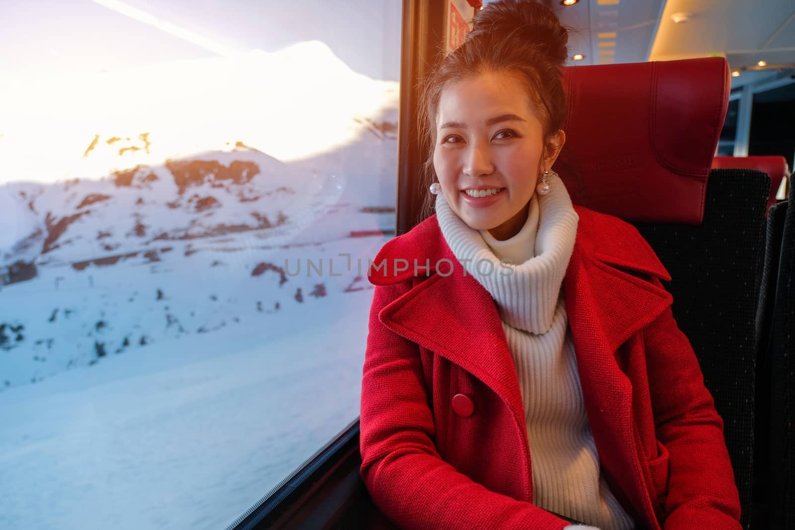 Young woman traveling looking view while sitting in the train.