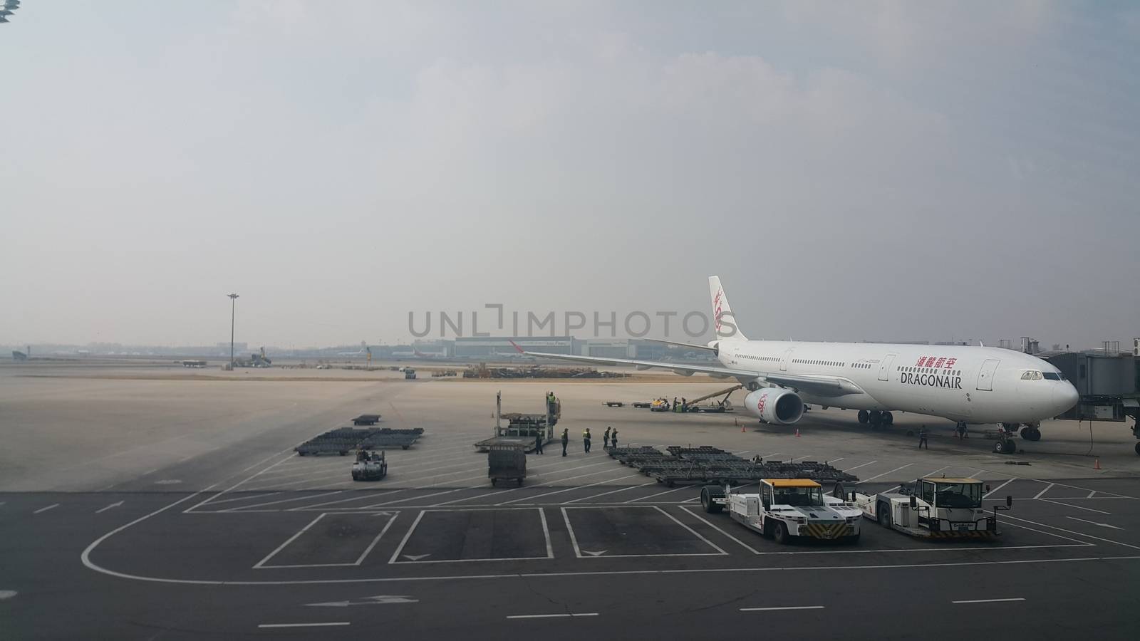 Beijing Airport, china- April 2019: Passenger plane standing in airport on the concrete paved runway terminal for loading, boarding and maintenance before take off for predestined flights.