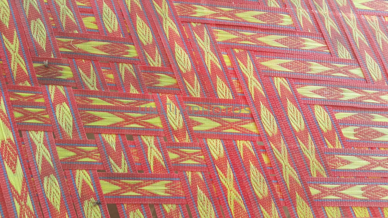Colorful plastic woven stripes of traditional bed used in rural areas.
