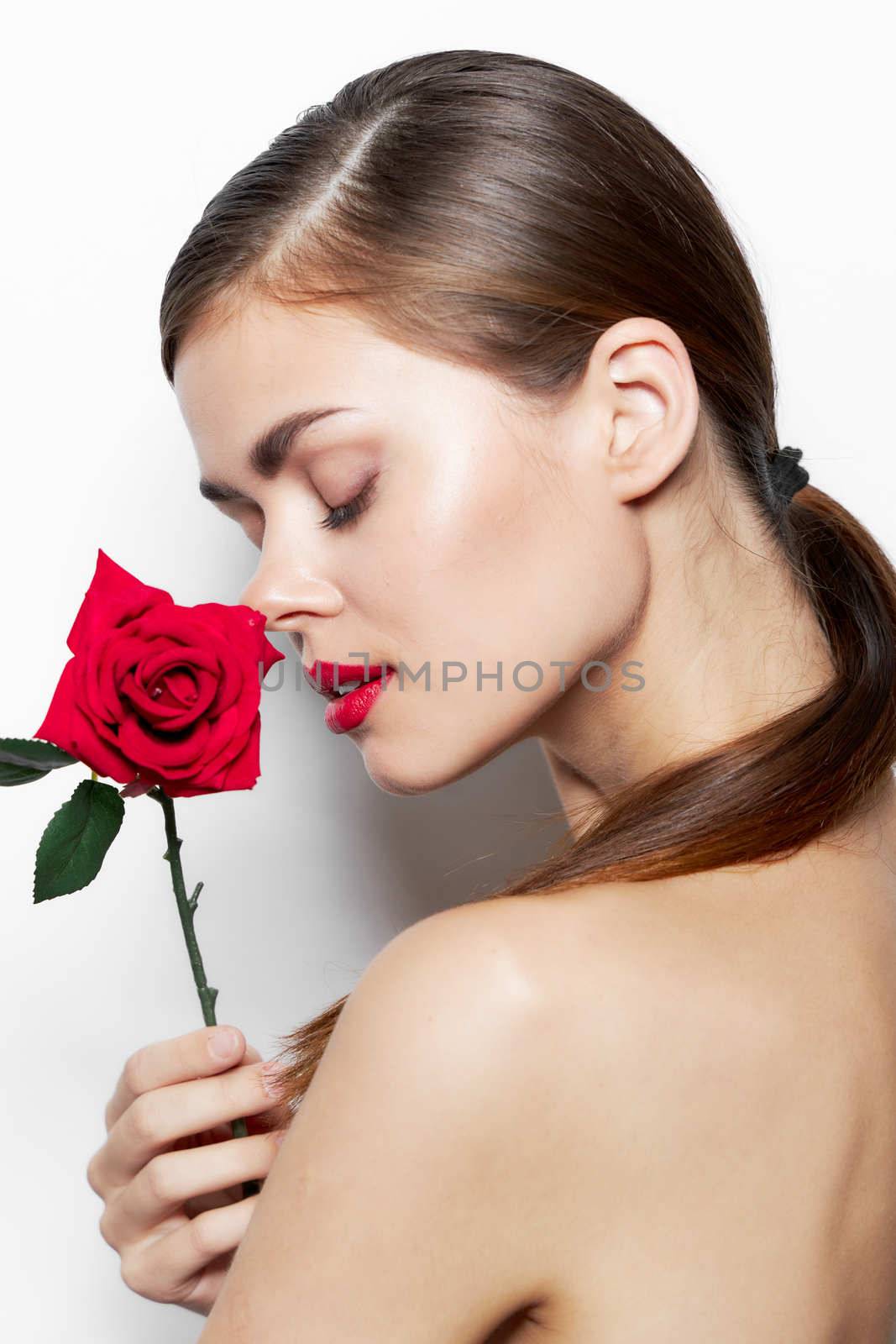Girl with flower Closed eyes red lips bared shoulders