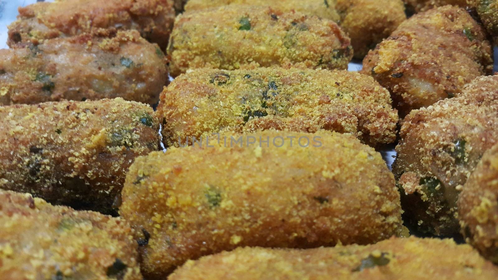 Closeup perspective view of home made spicy and delicious croquettes served with tea or other dishes during parties as fast food.