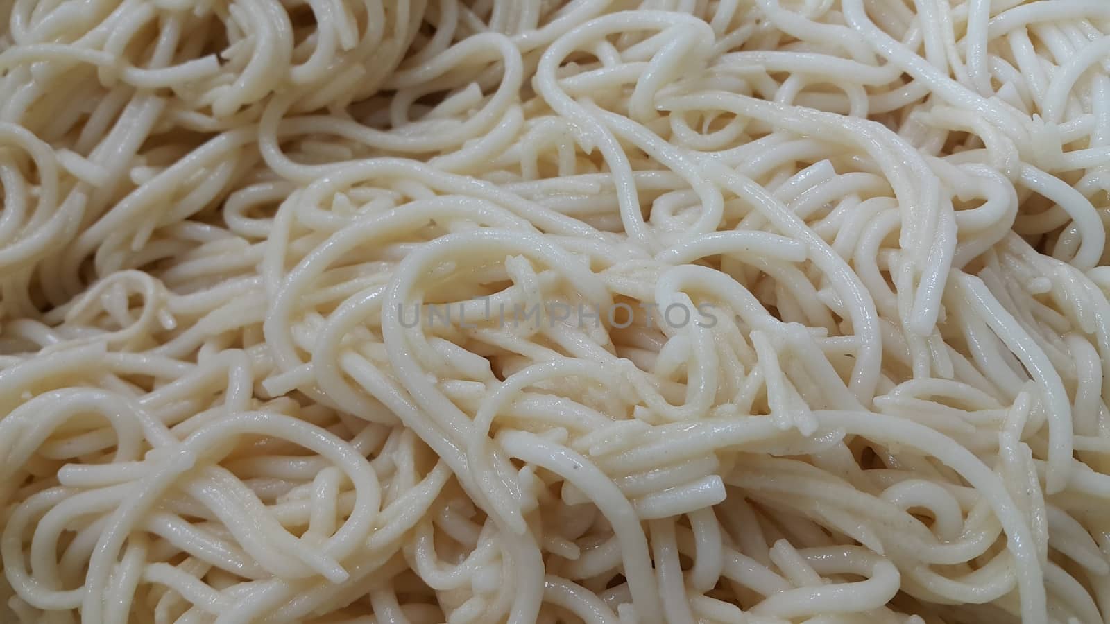 close up view of swirling noodles or spaghetti pasta for eating. Food background for fast foods