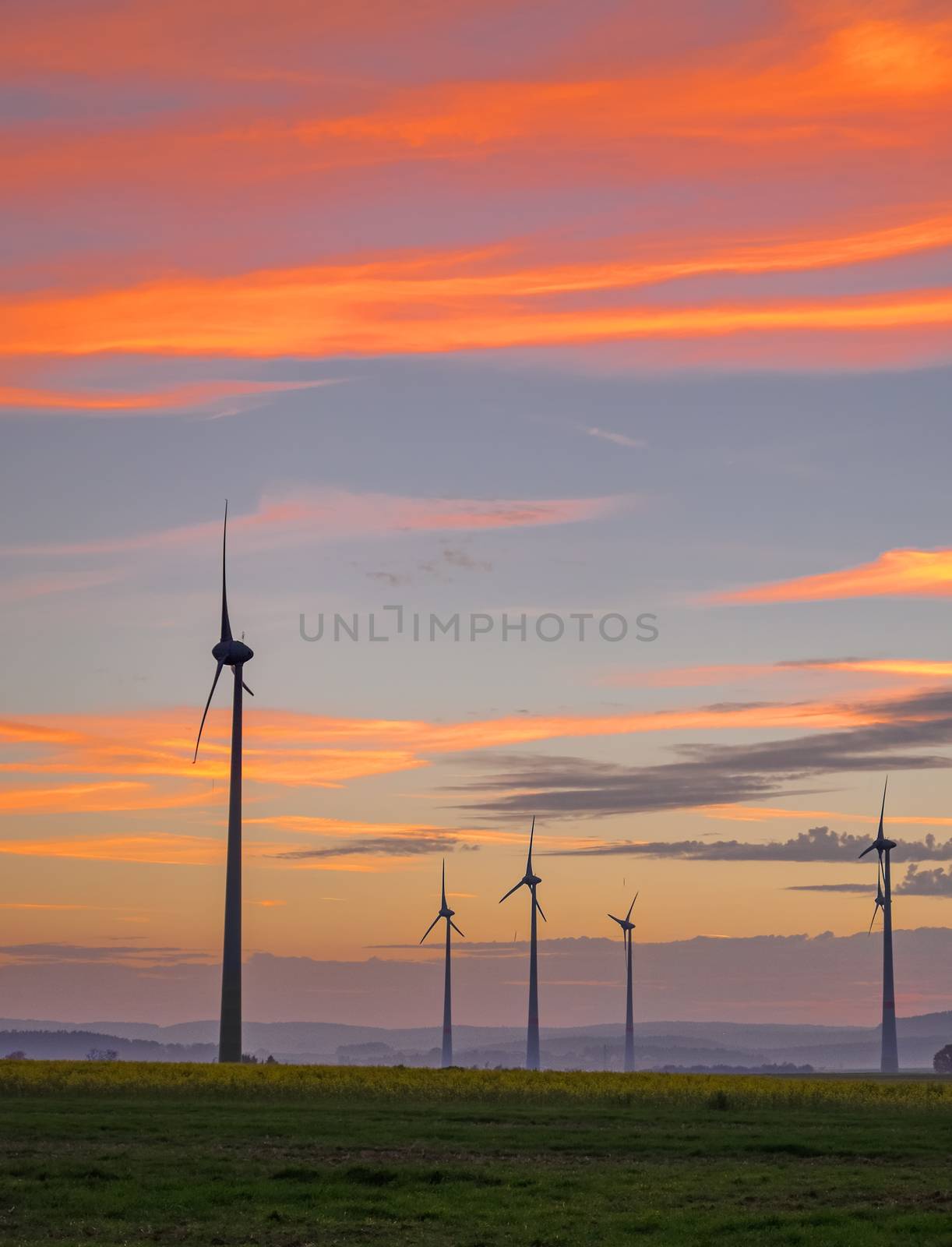 A few wind engines in front of an evening sky