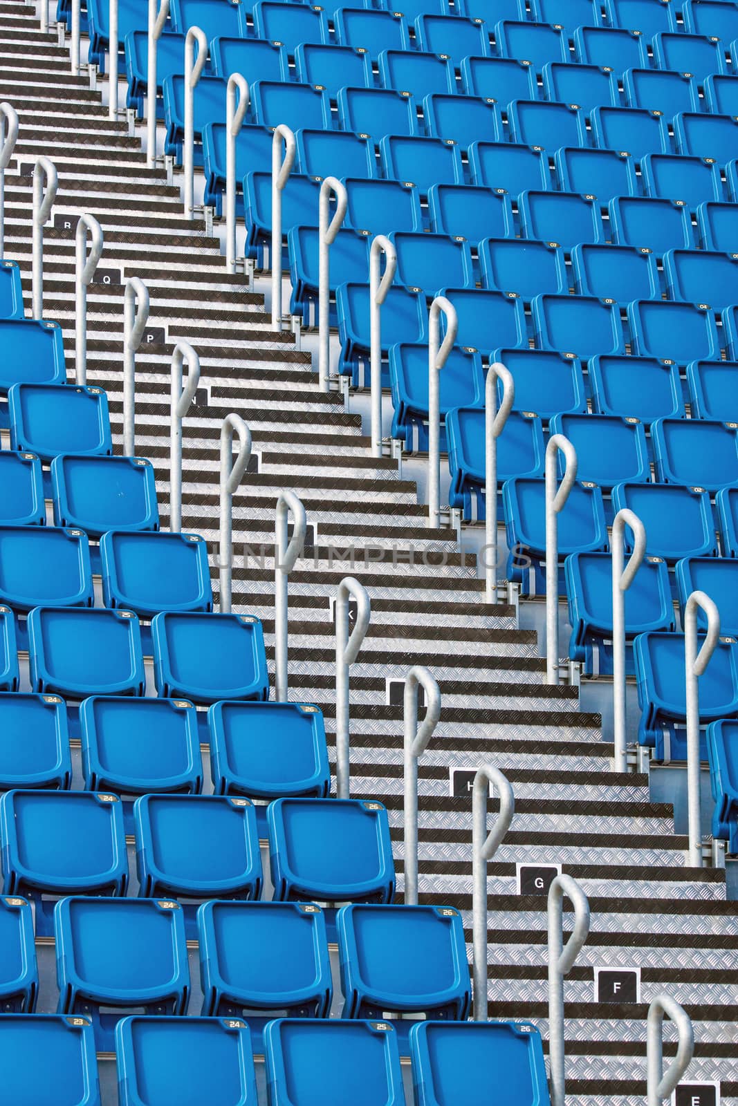 Blue stadium seats and a metallic staircase