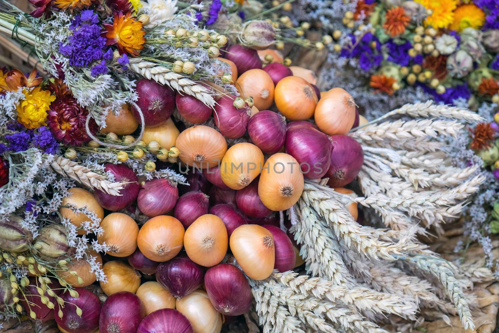 A decoration for a festival with onion, flowers and corn