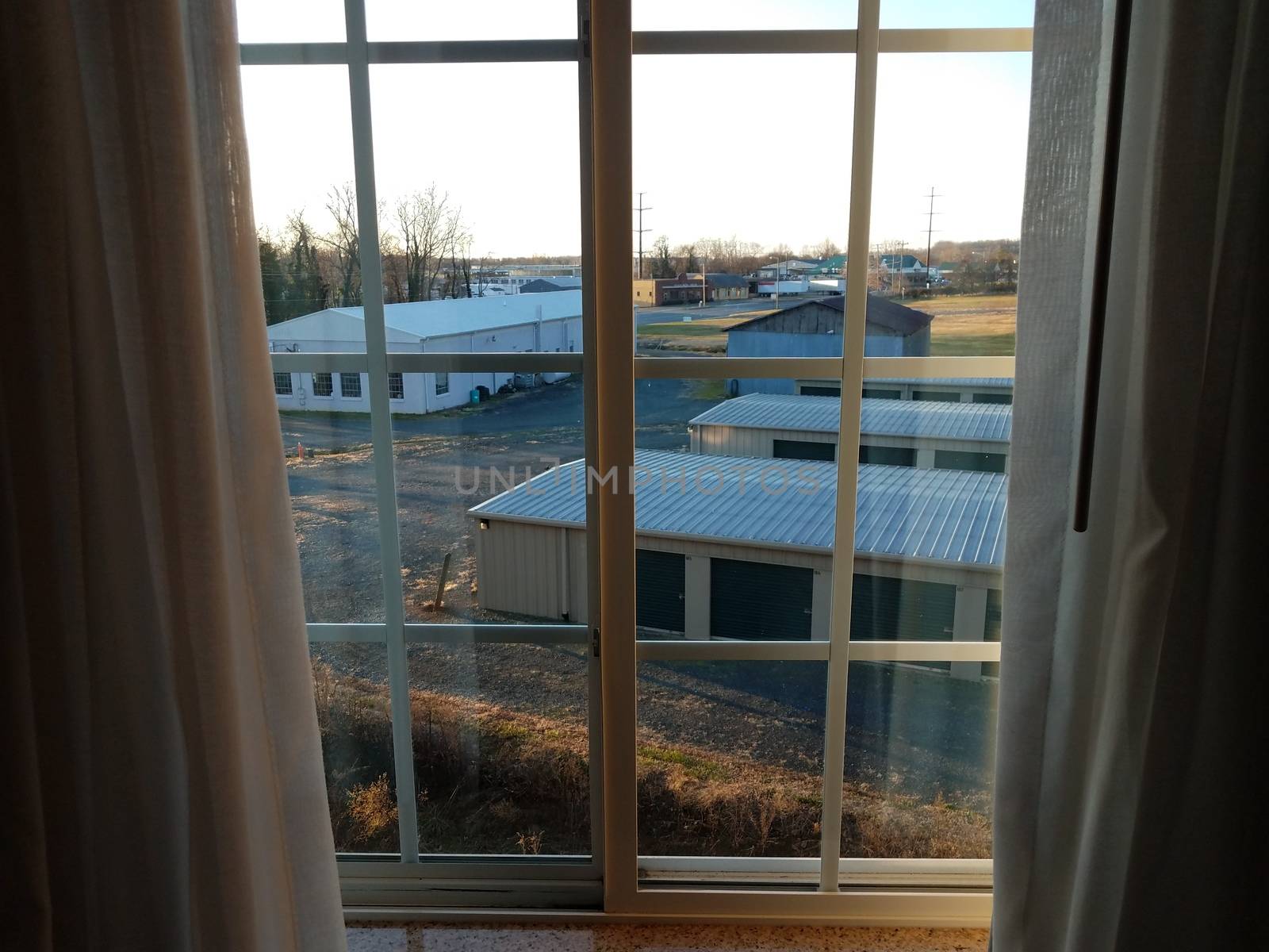 view of structures or buildings from window with curtains