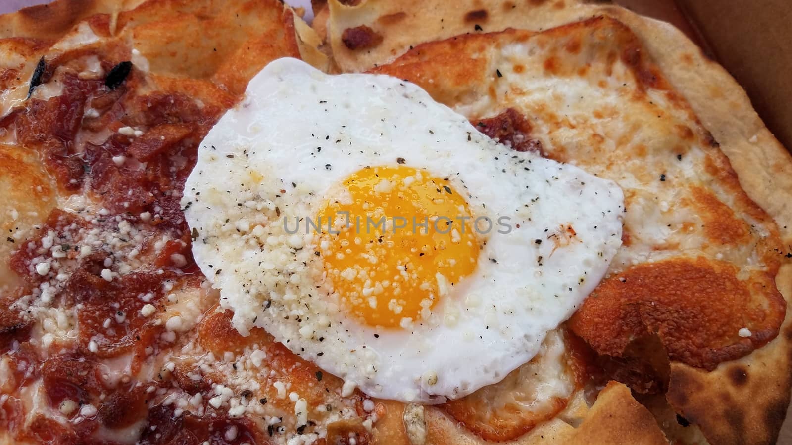 egg and bacon breakfast pizza in cardboard box by stockphotofan1