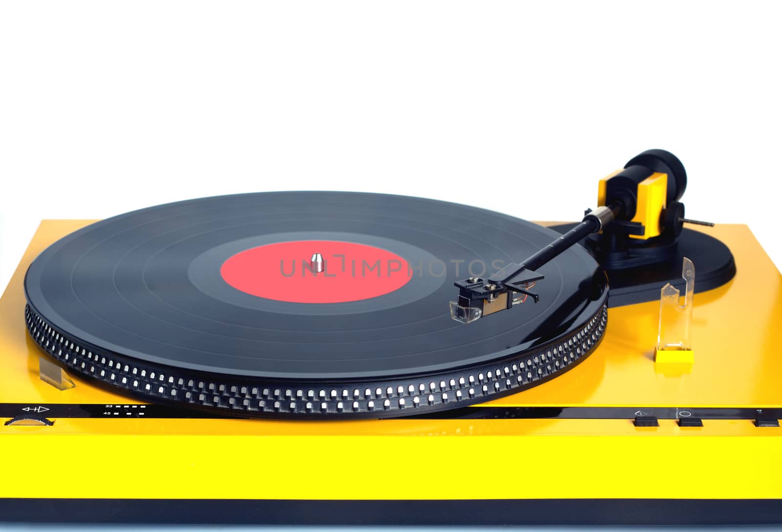 Modern turntable in silver case with rotation vinyl record with red label isolated on white background. Horizontal photo front view close-up by dymaxfoto