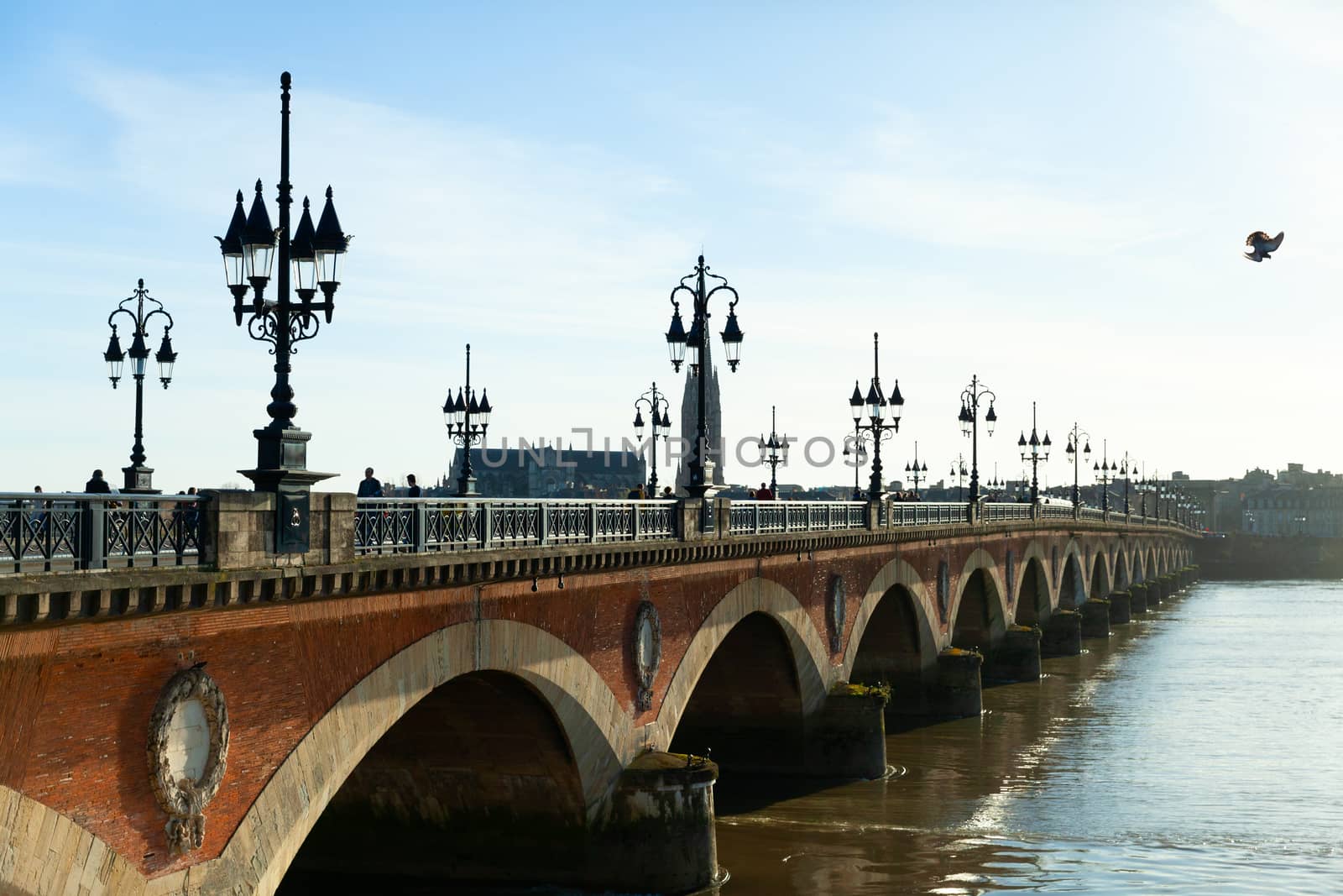 Pont de pierre (Stone Bridge) on a bright sunny day, Bordeaux, France by vlad-m