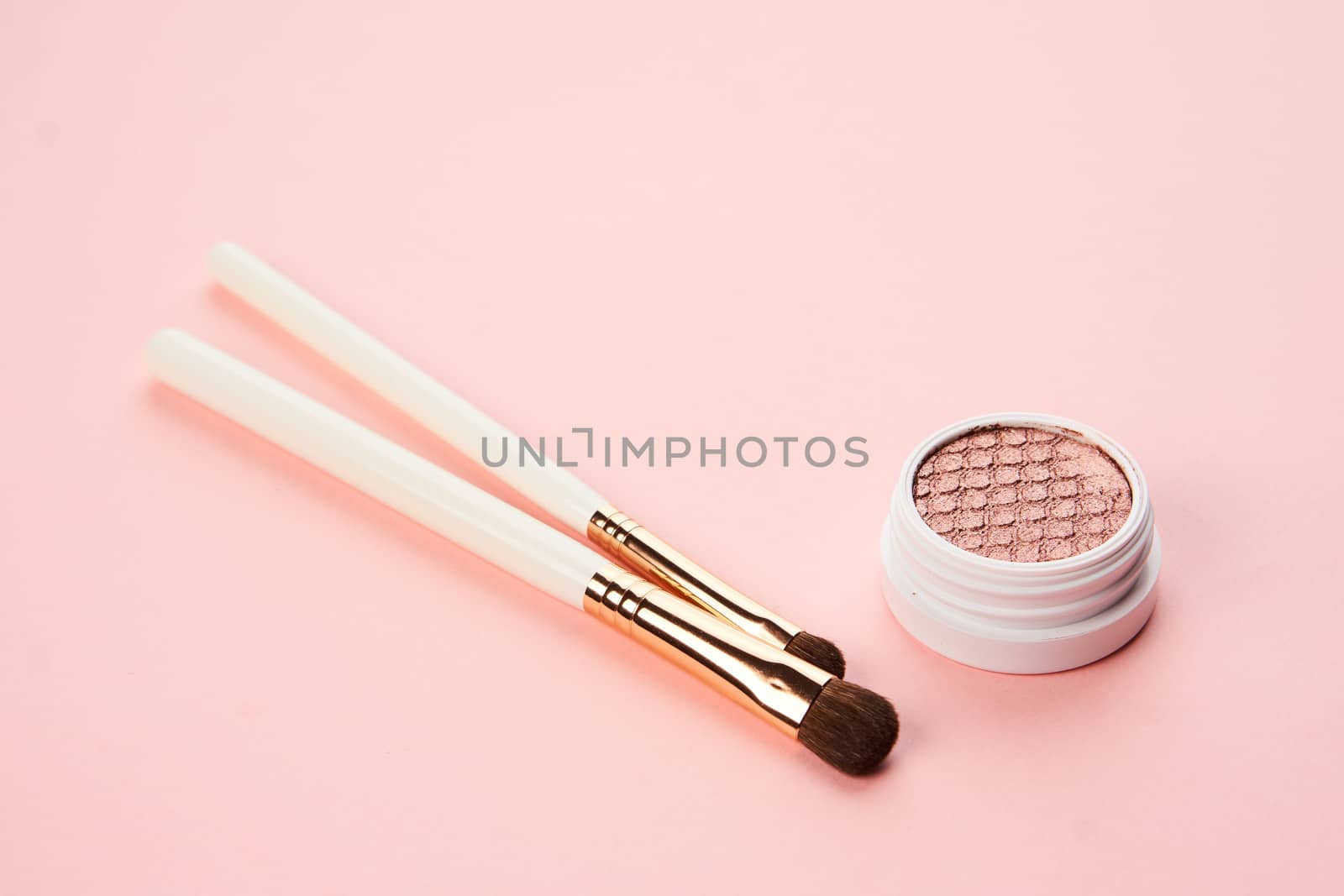 makeup brushes and eyeshadow professional cosmetics on pink background. High quality photo