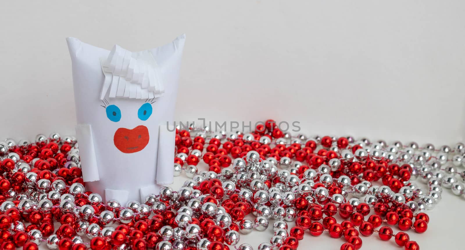 White paper bull as a symbol of New year and Christmas 2021 with red and silver beads on a white background by lapushka62