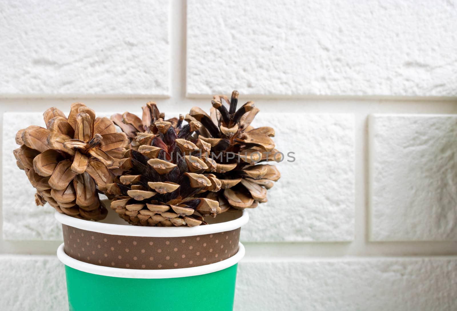 Pine cones lie on white bricks.The concept of a new year, Christmas, holiday