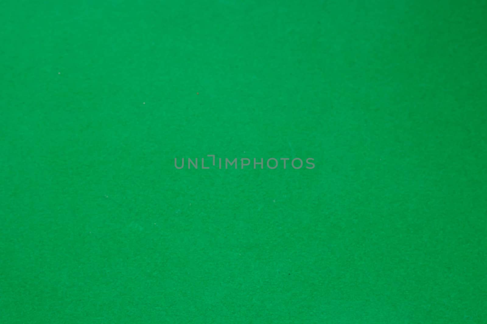 Dark green matte background of suede fabric, closeup