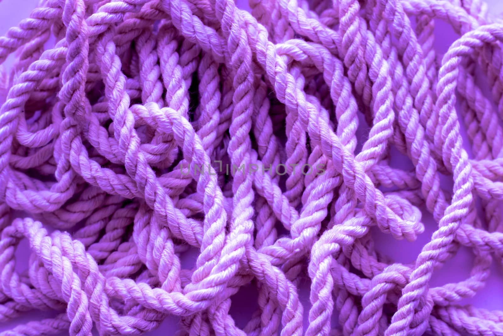 Sea rope, clothesline, close-up background texture, lilac background