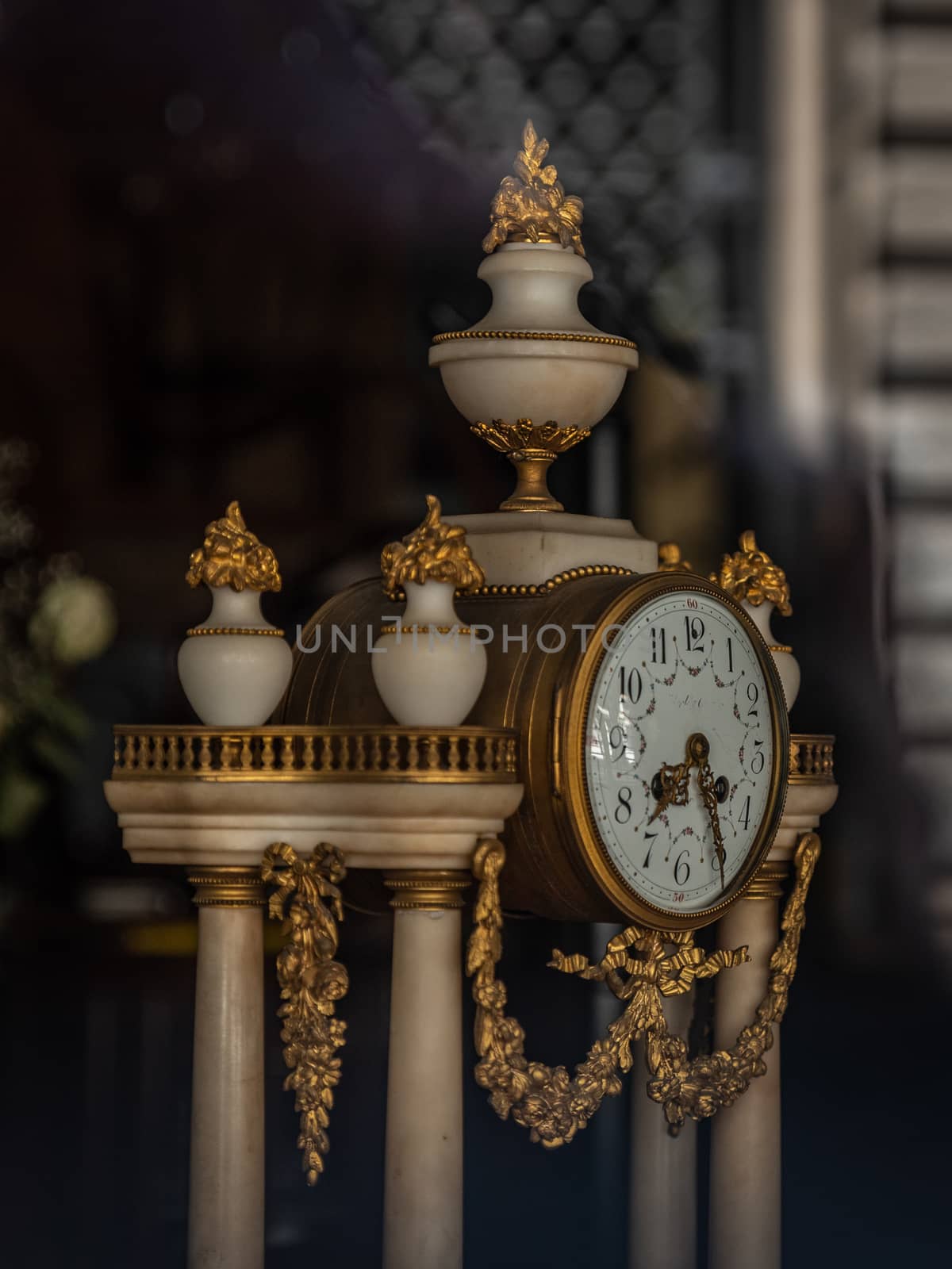 Antique table clock with marble and gold details, historical object