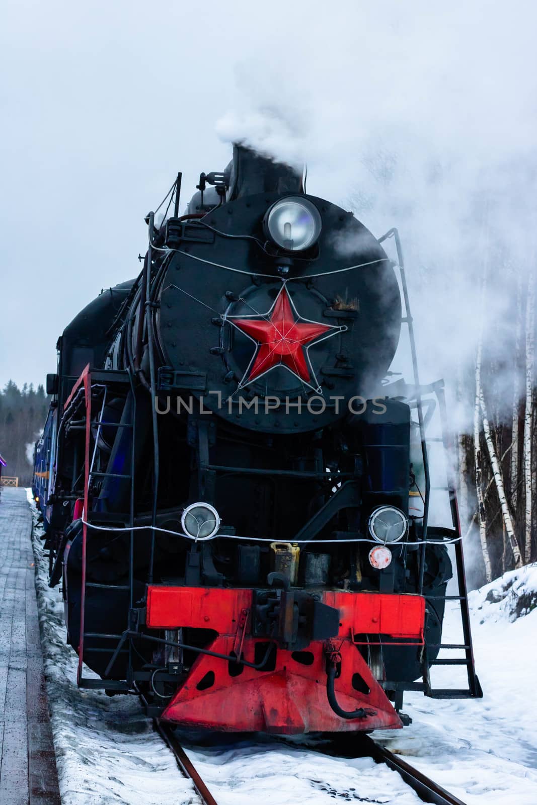 Vintage black steam locomotive train rush railway. winter