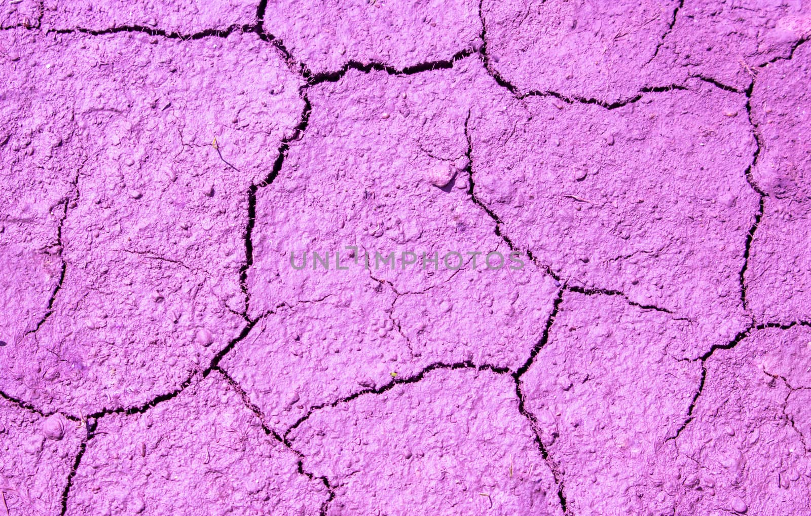 Pink cracked surface with a rough texture.Abstract background.