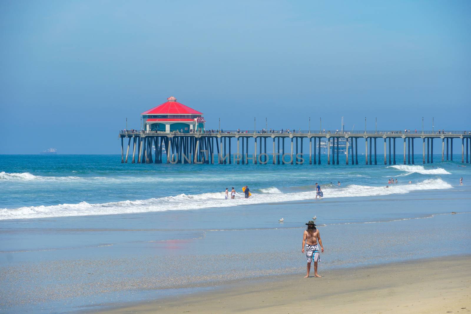 Aerial view of Huntington Pier, beach and coastline during sunny summer day by Bonandbon