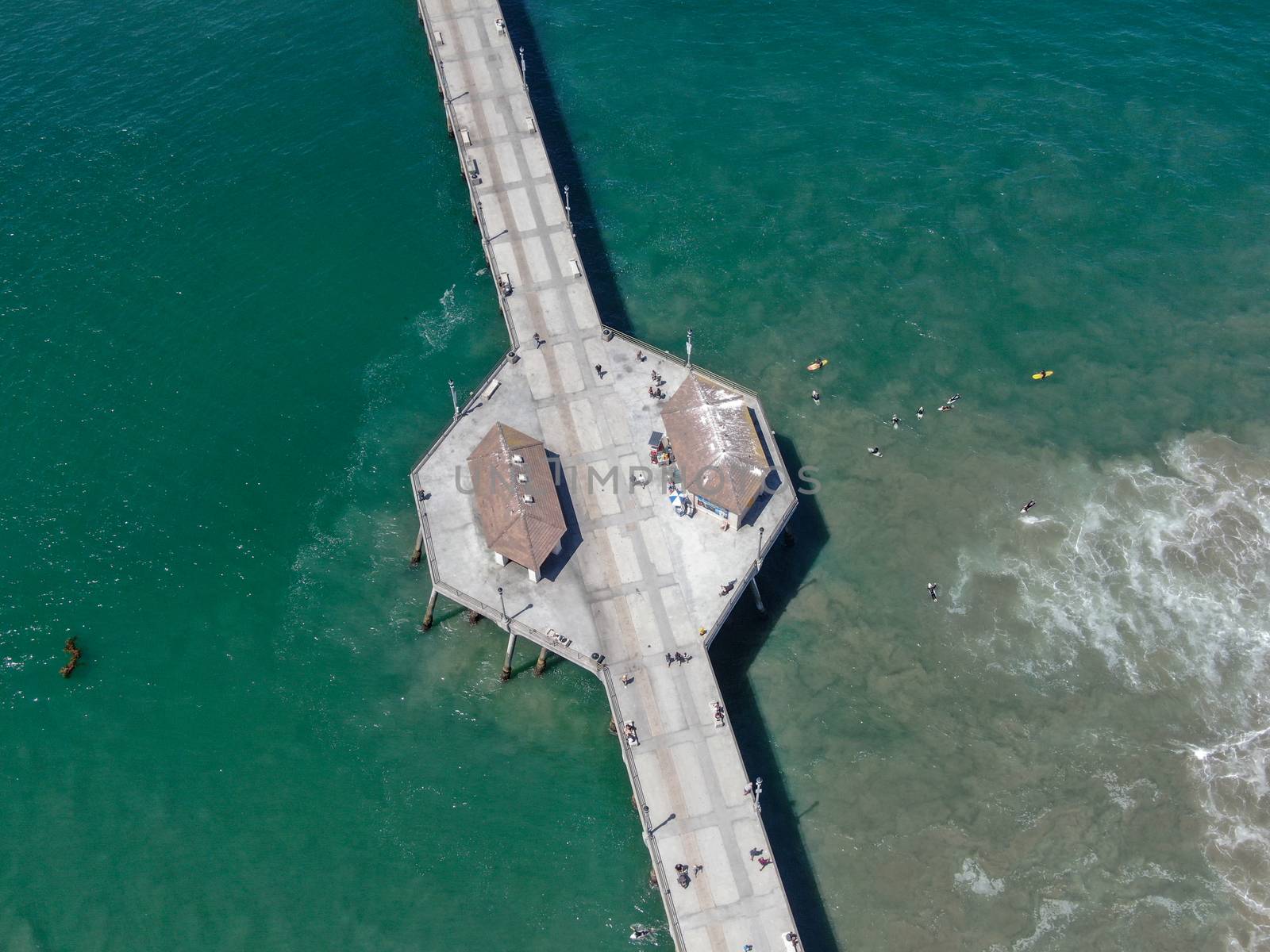 Aerial view of Huntington Pier, beach and coastline during sunny summer day, Southeast of Los Angeles. California. destination for surfer and tourist.