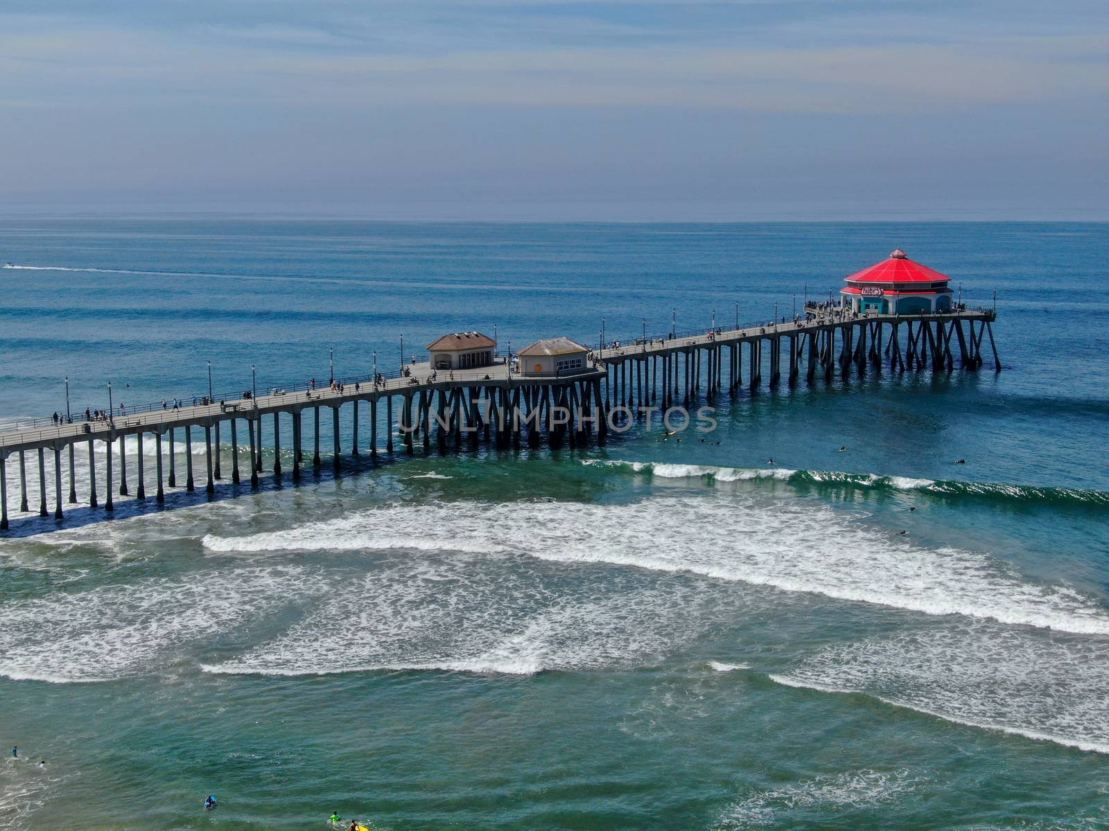 Aerial view of Huntington Pier, beach and coastline during sunny summer day, Southeast of Los Angeles. California. destination for surfer and tourist.